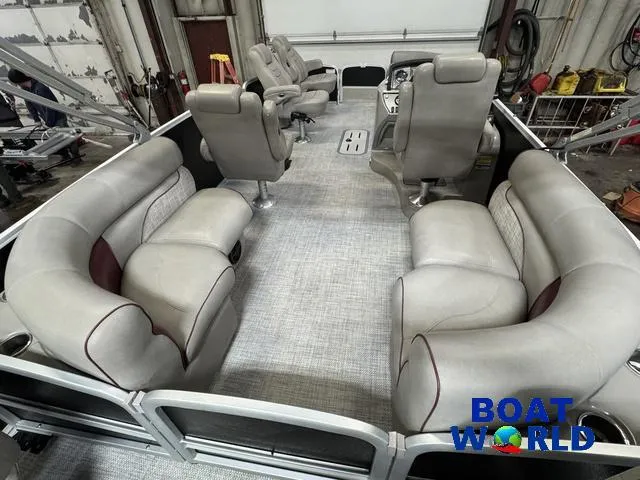 Slide: The Image of 2019 Premier Alante 240 DL pontoon boat interior with plush seating in a showroom. - 24