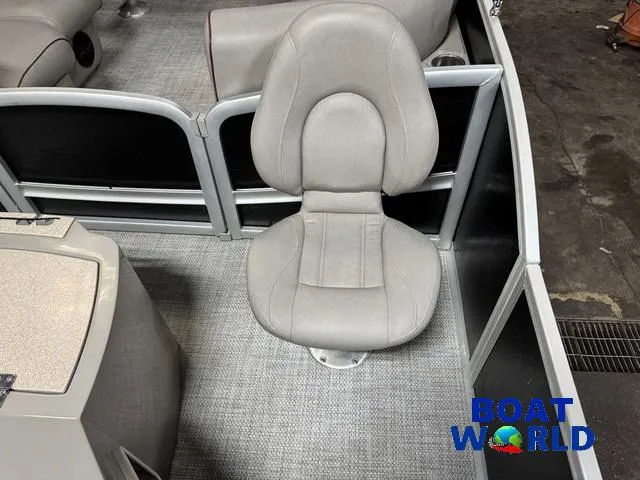Slide: The Image of 2019 Premier Alante 240 DL boat interior with gray captain's chair and carpeted flooring. - 26