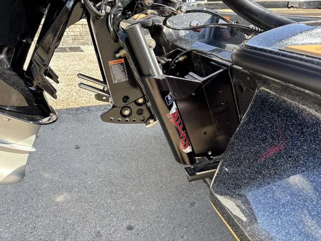 Slide: The Image of 2025 Caymas XS 21 Pro boat engine mount detail with hydraulic components. - 3