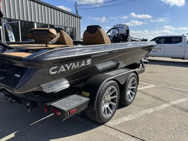 Slide: The Image of 2025 Caymas XS 21 Pro boat on trailer, parked outdoors under a clear sky. - 5