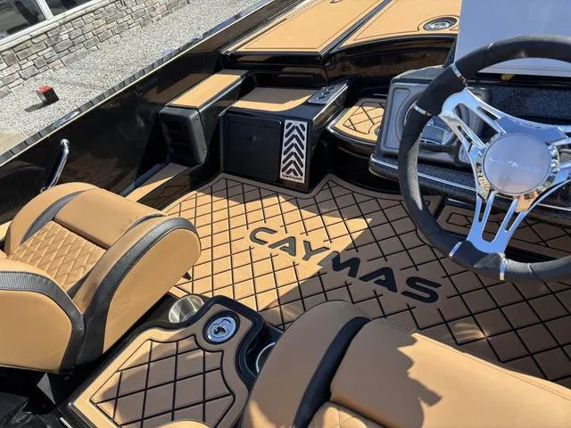 Slide: The Image of 2025 Caymas XS 21 Pro boat interior with tan seats and steering wheel. - 9