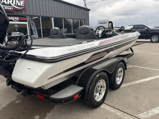 Slide: The Image of 2015 Skeeter ZX 225 boat on trailer, parked outside a marine shop. - 3