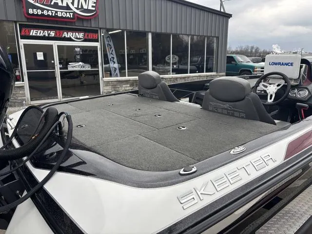 Slide: The Image of 2015 Skeeter ZX 225 bass boat at dealership, featuring spacious deck and modern controls. - 4