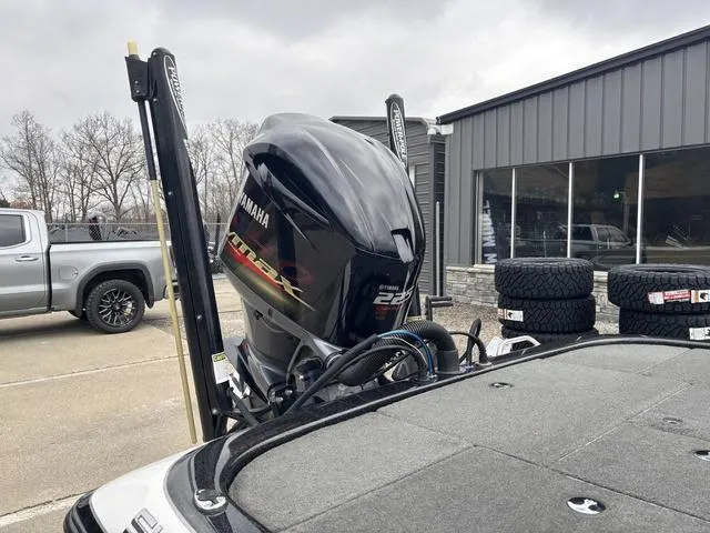 Slide: The Image of 2015 Skeeter ZX 225 boat with Yamaha engine, parked near a building and tires. - 5