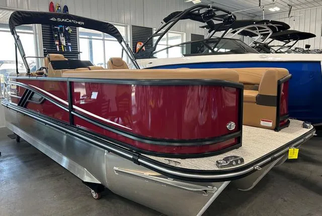 Slide: The Image of 2025 SunCatcher 322rc pontoon boat with red exterior in showroom. - 1