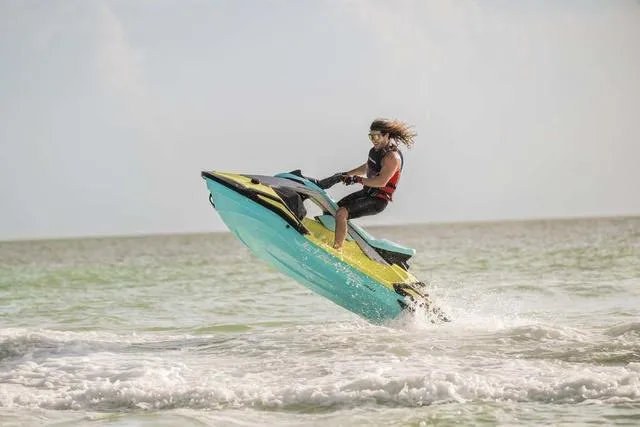 Slide: The Image of 2025 Yamaha Waverunner Jetblaster performing a jump on the ocean waves. - 6
