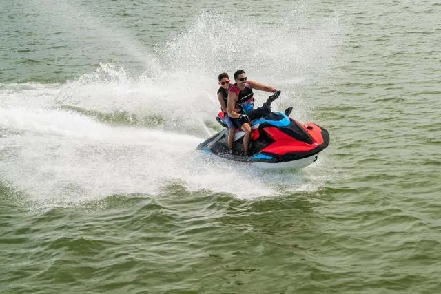 Slide: The Image of 2025 Yamaha Waverunner Jetblaster speeding on water with two riders. - 4