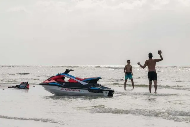 Slide: The Image of 2025 Yamaha Waverunner Jetblaster on beach with two people playing catch in the water. - 5