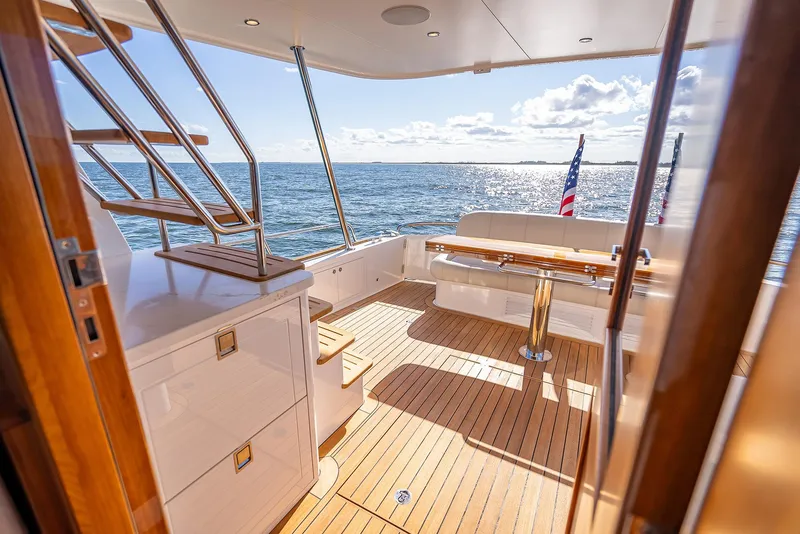Slide: The Image of Luxurious 2026 Grand Banks GB 54 yacht deck with ocean view and elegant seating. - 15