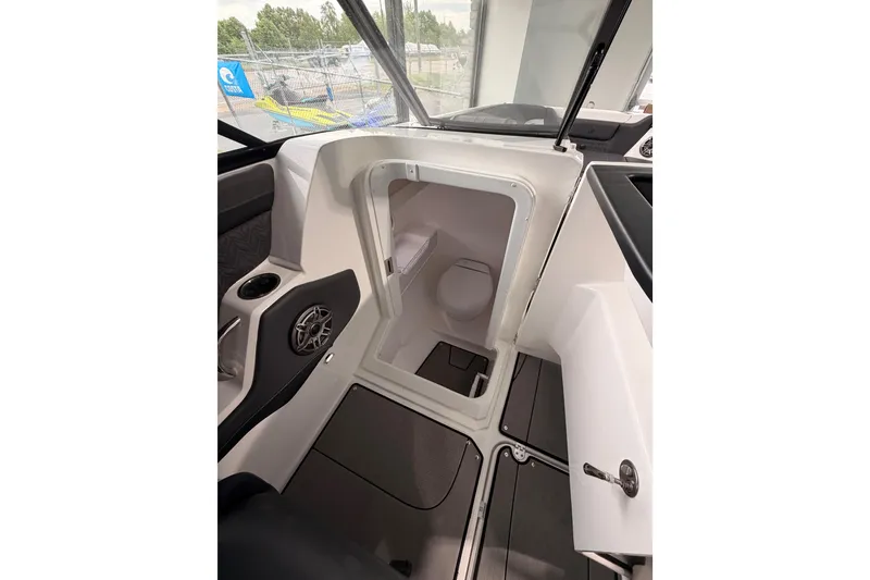 Slide: The Image of 2025 Hurricane Sundeck SD 2600 OB boat interior with compact restroom. - 19