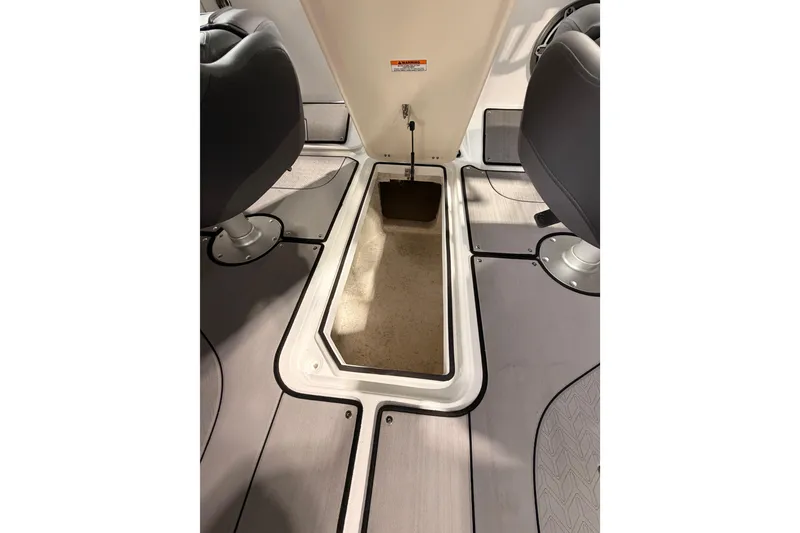 Slide: The Image of 2025 Hurricane Sundeck SD 2600 OB interior storage compartment between seats. - 22