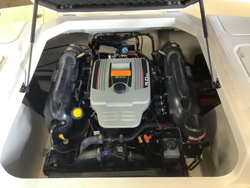 Slide: The Image of Engine compartment of a 2016 Chaparral 21 H2O boat, featuring a 5.0 MPI engine. - 11