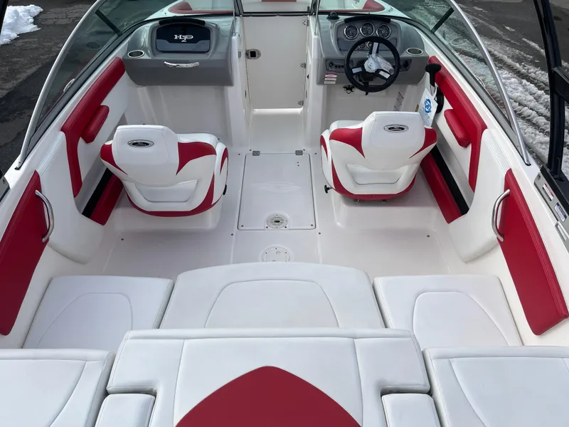 Slide: The Image of 2016 Chaparral 21 H2O boat interior with red and white seating, steering wheel, and dashboard. - 4
