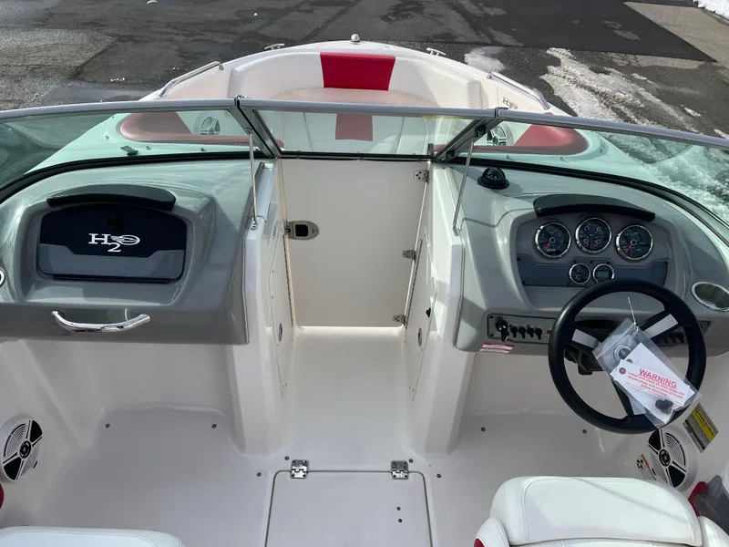 Slide: The Image of 2016 Chaparral 21 H2O boat interior with steering wheel and dashboard controls. - 7