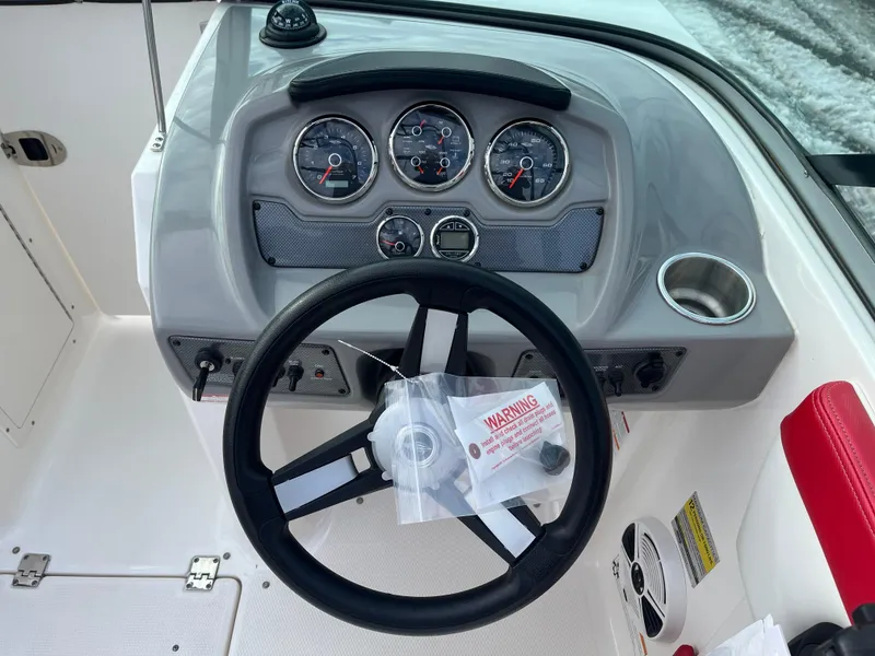 Slide: The Image of Dashboard of a 2016 Chaparral 21 H2O boat with steering wheel and gauges. - 9