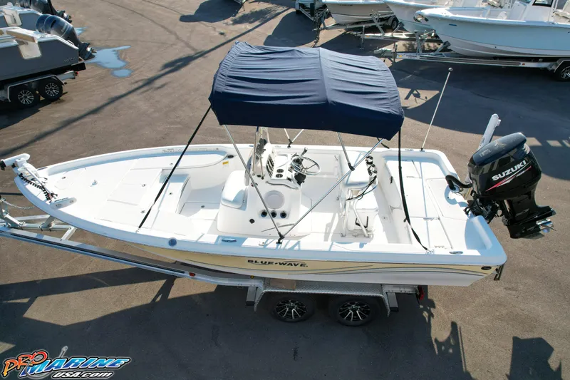 Slide: The Image of 2011 Blue Wave 2200 Pure Bay boat with canopy and Suzuki outboard motor on trailer. - 17