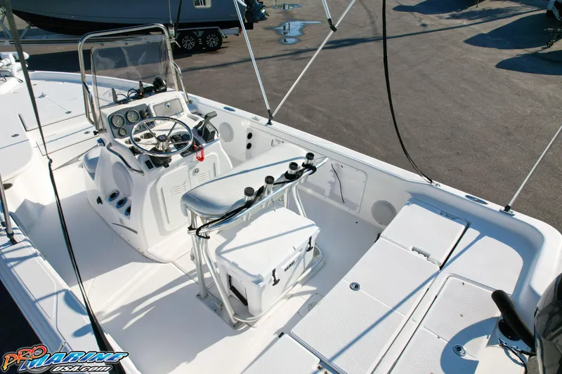 Slide: The Image of 2011 Blue Wave 2200 Pure Bay boat interior with steering console and seating. - 23
