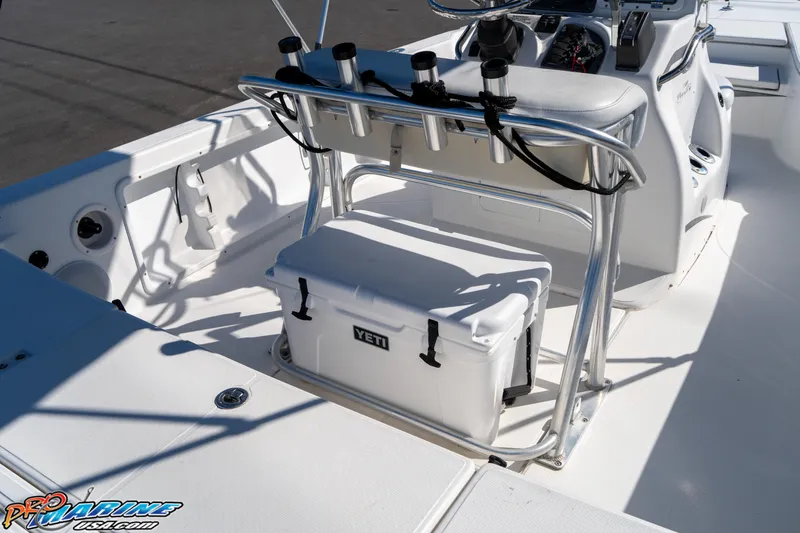 Slide: The Image of 2011 Blue Wave 2200 Pure Bay boat interior with Yeti cooler and rod holders. - 26