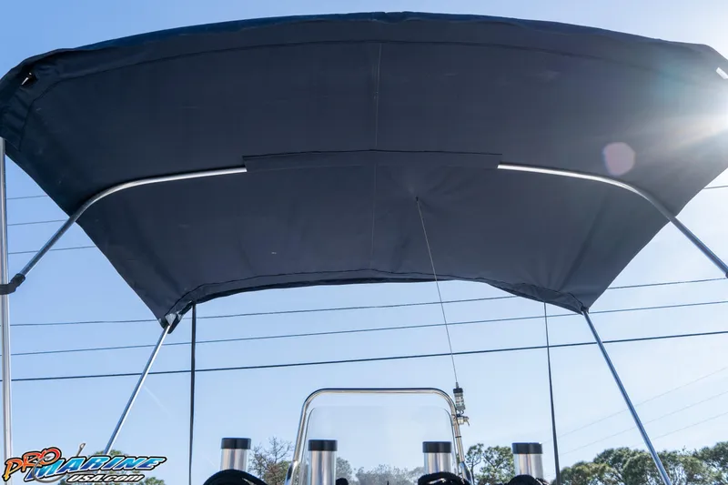 Slide: The Image of Bimini top on a 2011 Blue Wave 2200 Pure Bay boat under clear sky. - 27