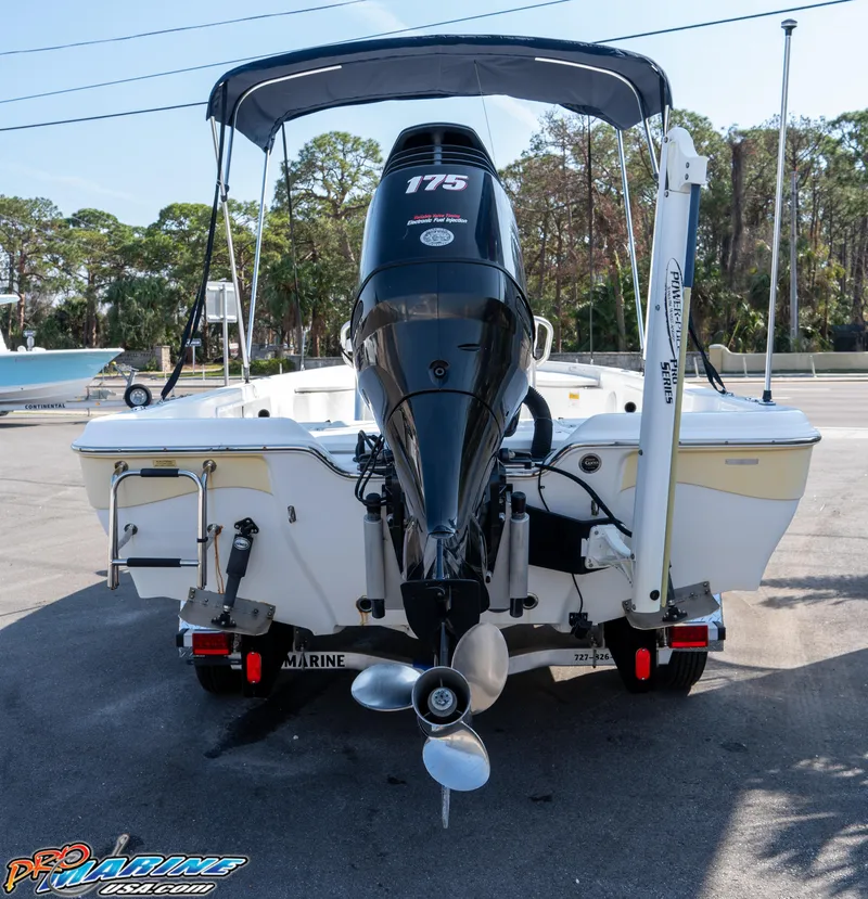 Slide: The Image of 2011 Blue Wave 2200 Pure Bay boat with 175 HP engine, parked outdoors. - 4