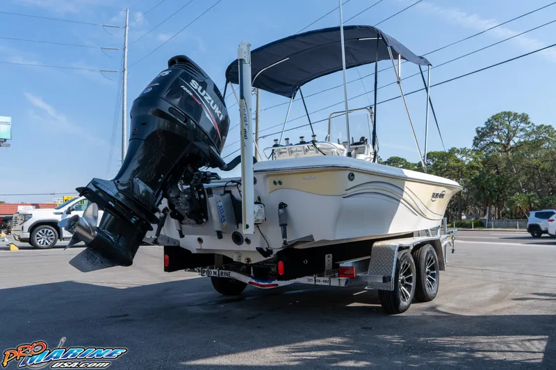 Slide: The Image of 2011 Blue Wave 2200 Pure Bay boat on trailer with Suzuki outboard motor. - 5