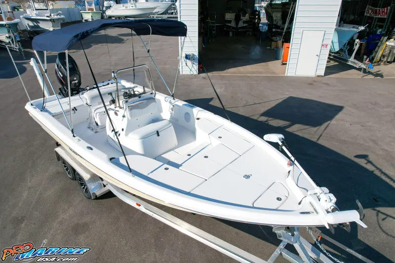 Slide: The Image of 2011 Blue Wave 2200 Pure Bay boat on trailer, featuring a sleek design and spacious deck. - 9