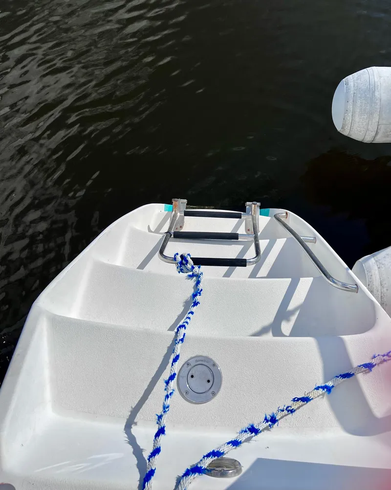 Slide: The Image of Stern of 1994 PDQ 32 Classic boat with ladder and blue rope. - 15