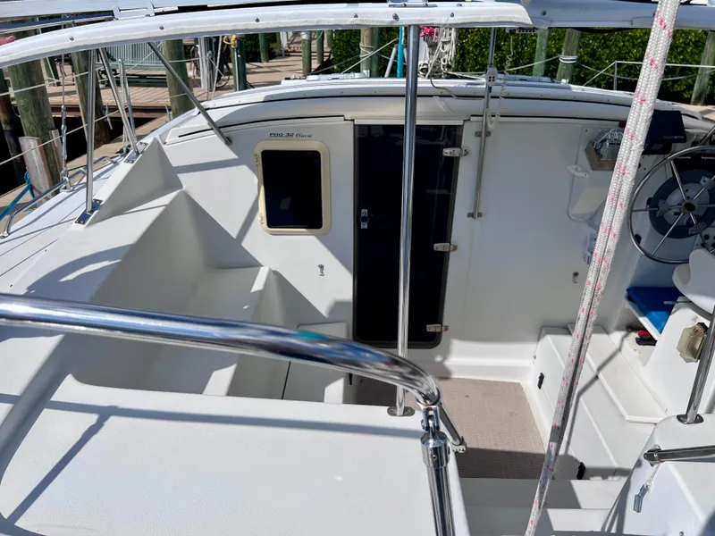 Slide: The Image of Cockpit of a 1994 PDQ 32 Classic sailboat with steering wheel and seating area. - 17