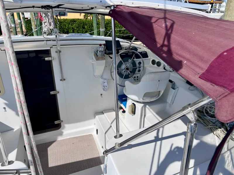 Slide: The Image of Interior view of a 1994 PDQ 32 Classic sailboat cockpit with steering wheel. - 19
