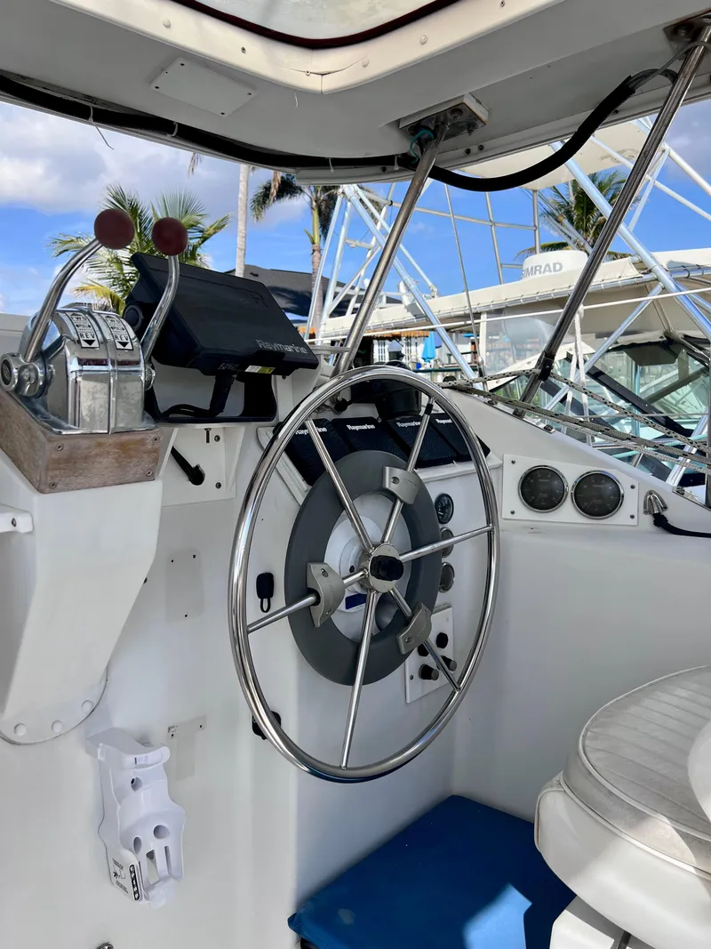 Slide: The Image of Interior view of a 1994 PDQ 32 Classic boat cockpit with steering wheel and controls. - 21