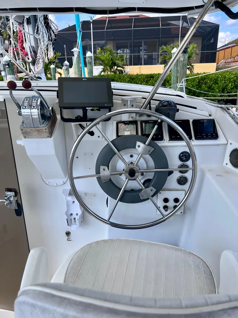 Slide: The Image of Helm of 1994 PDQ 32 Classic boat with steering wheel and navigation equipment. - 22