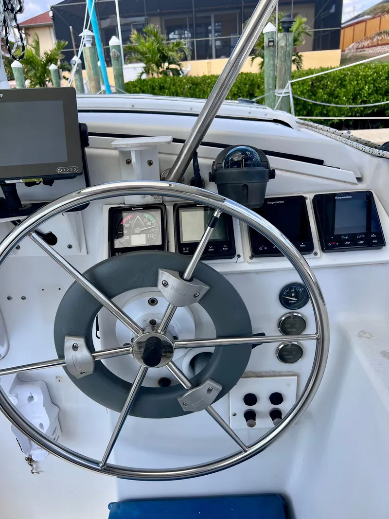 Slide: The Image of Steering wheel and dashboard of a 1994 PDQ 32 Classic boat. - 24