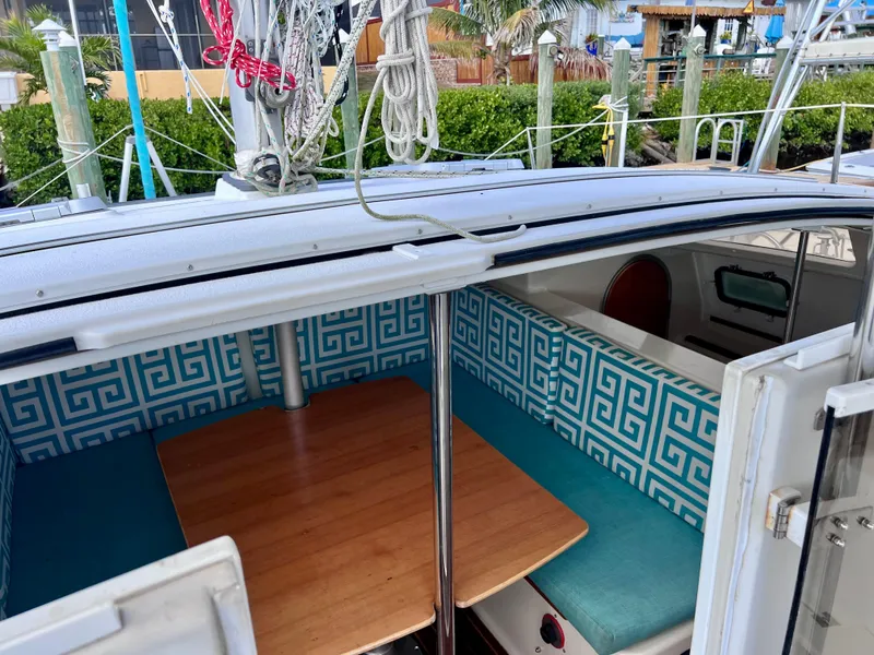 Slide: The Image of Interior of 1994 PDQ 32 Classic sailboat with patterned seating and wooden table. - 28
