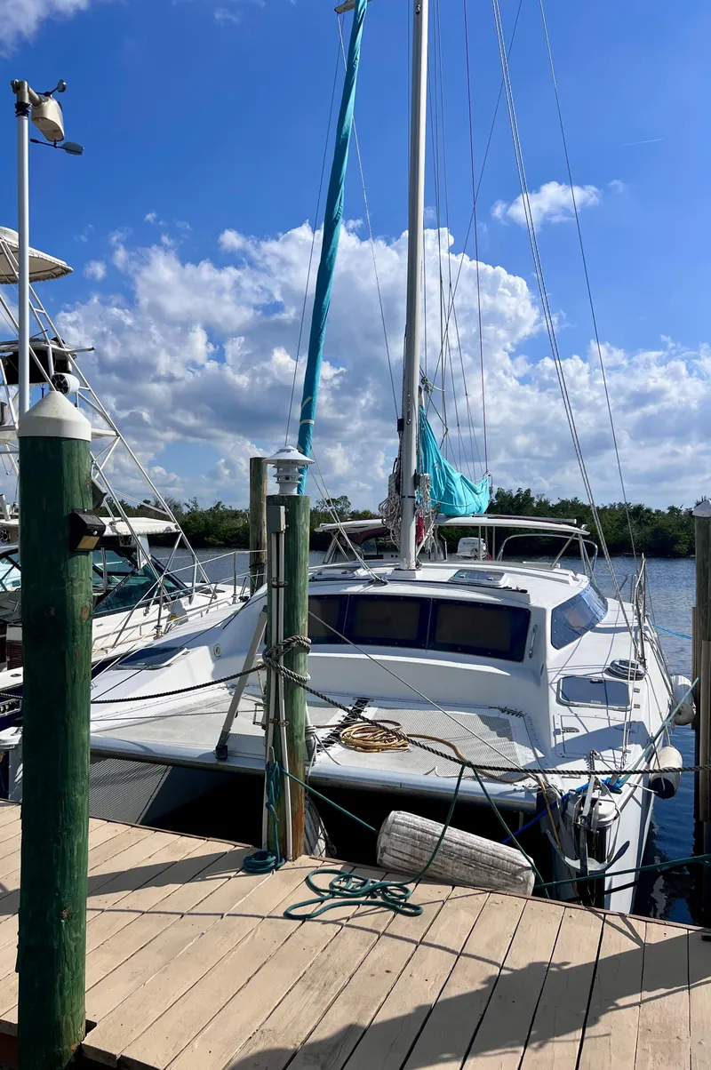 Slide: The Image of 1994 PDQ 32 Classic sailboat docked under a clear blue sky. - 3