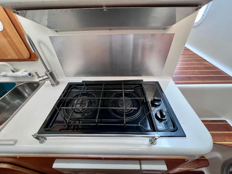 Slide: The Image of 1994 PDQ 32 Classic yacht kitchen with stove and sink. - 34