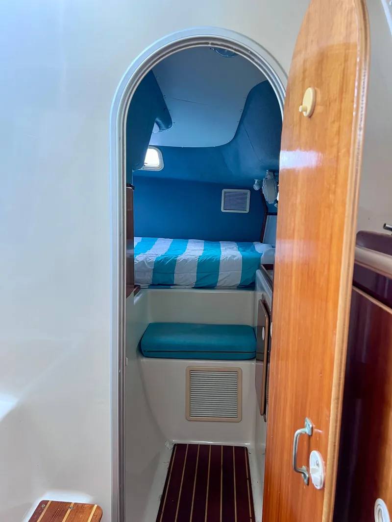 Slide: The Image of Interior cabin of 1994 PDQ 32 Classic boat with striped bedding. - 35