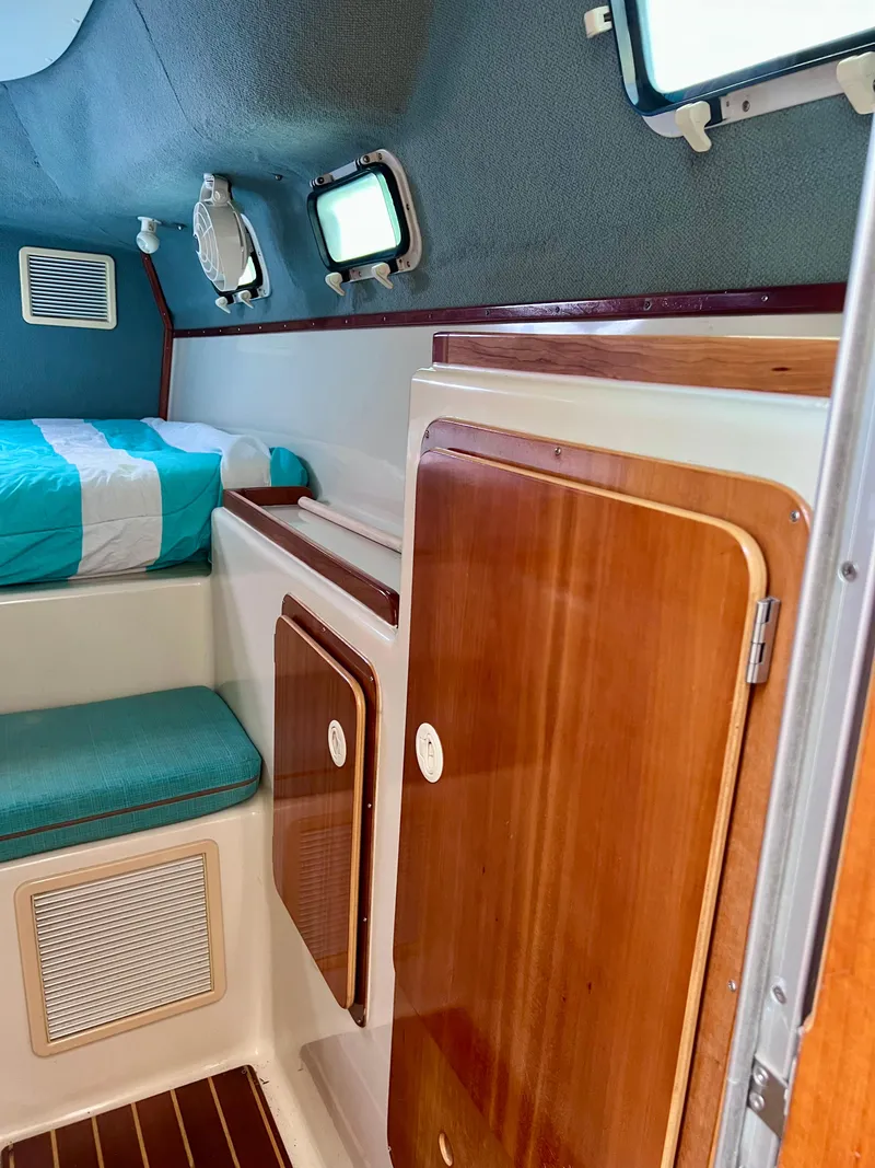 Slide: The Image of Interior of 1994 PDQ 32 Classic boat with wood cabinets and cozy sleeping area. - 36