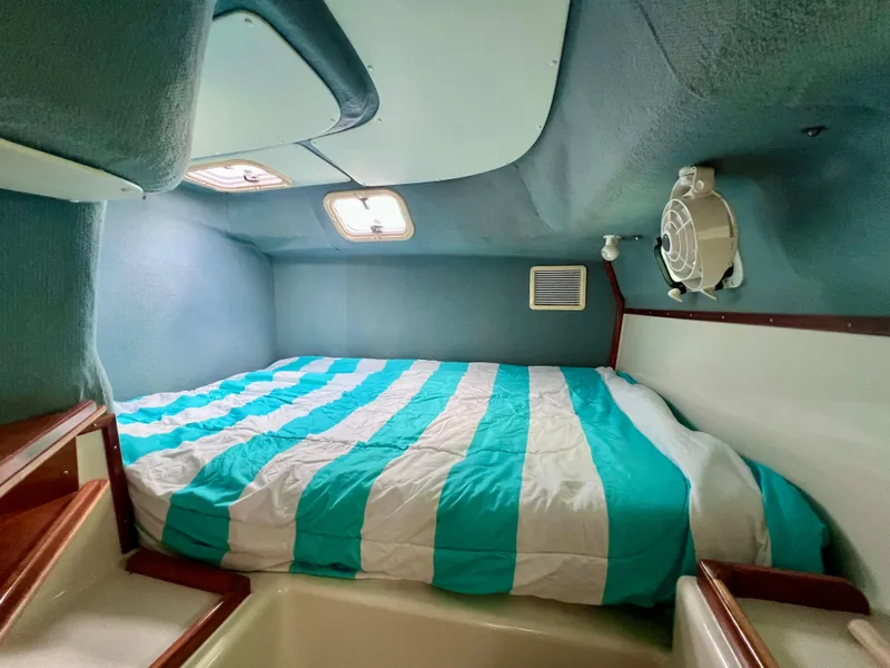 Slide: The Image of Cozy cabin interior of 1994 PDQ 32 Classic with striped bedding and wooden accents. - 37