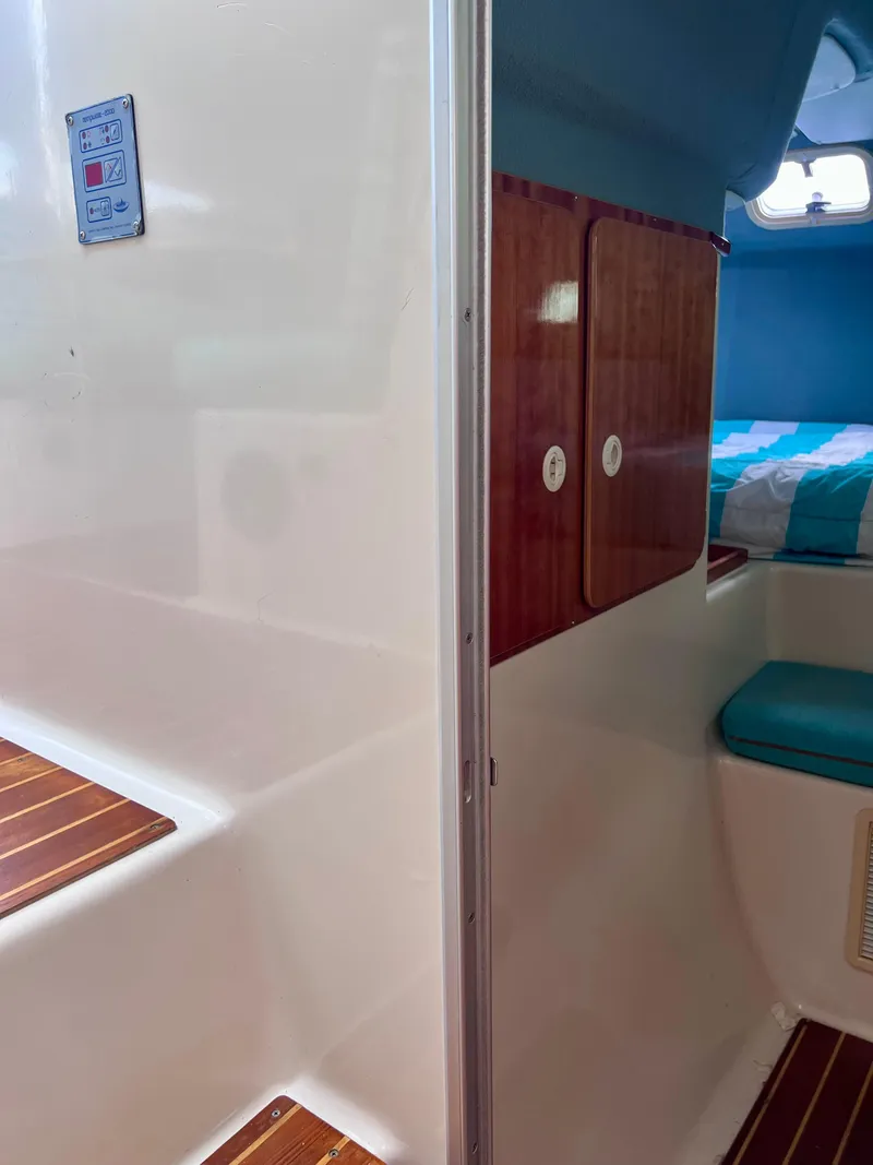 Slide: The Image of Interior of 1994 PDQ 32 Classic boat with wooden accents and seating area. - 43