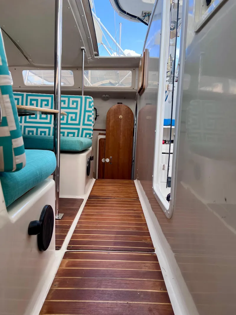 Slide: The Image of Interior of 1994 PDQ 32 Classic boat with wooden flooring and turquoise seating. - 45
