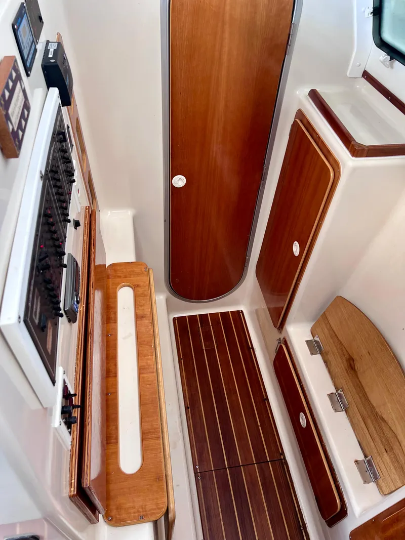 Slide: The Image of Interior of 1994 PDQ 32 Classic boat with wooden panels and control panel. - 47