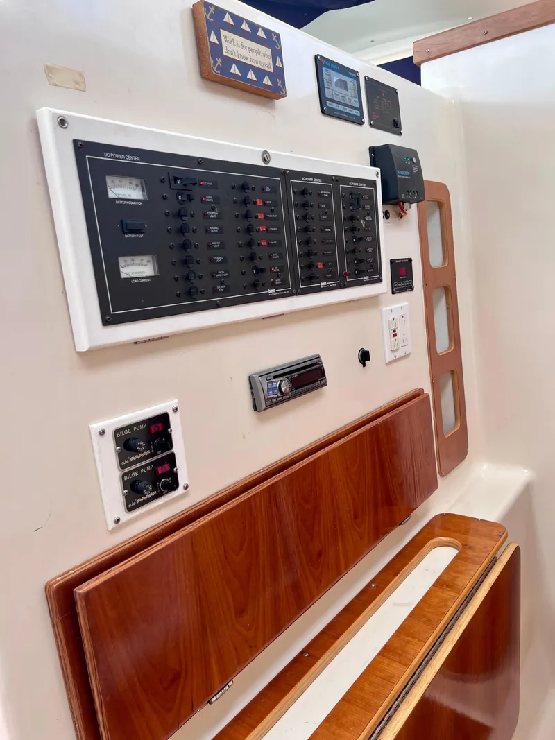 Slide: The Image of Control panel of a 1994 PDQ 32 Classic boat with wood accents. - 48