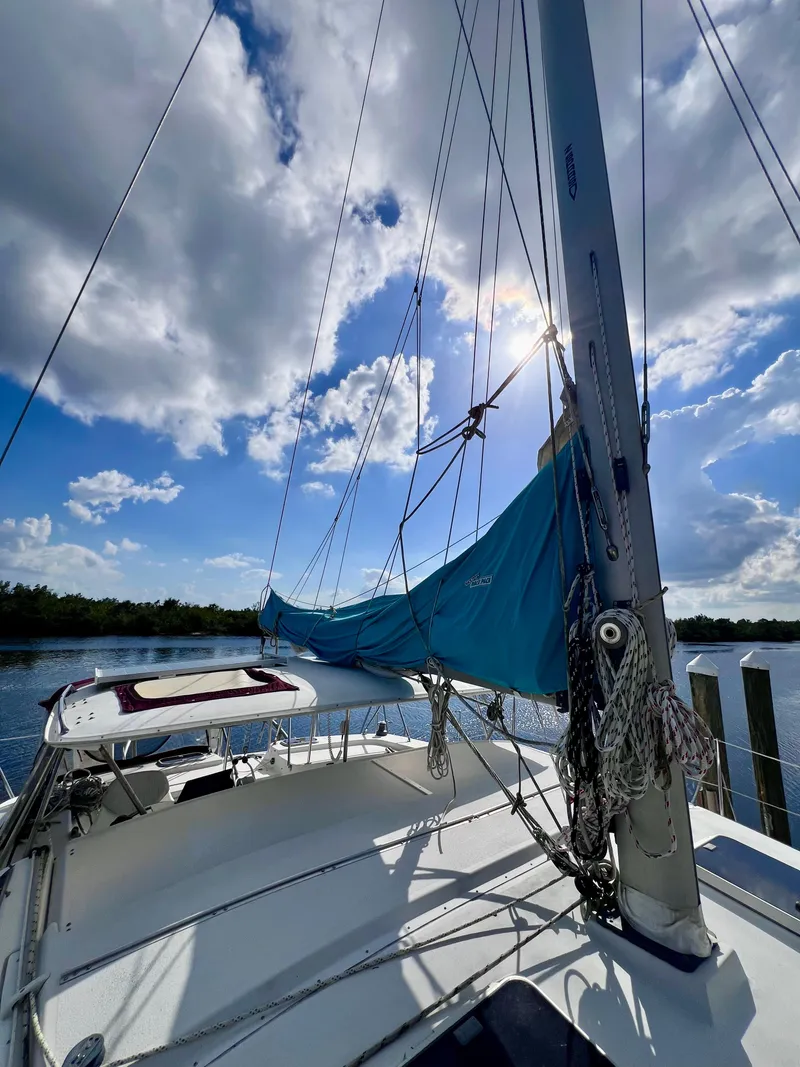 Slide: The Image of Sailboat PDQ 32 Classic 1994 on calm water under a partly cloudy sky. - 6