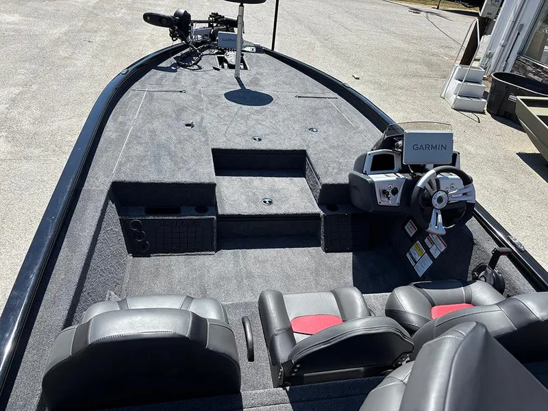 Slide: The Image of 2025 Tracker Savage 215 boat interior with Garmin navigation system and dual seating. - 10