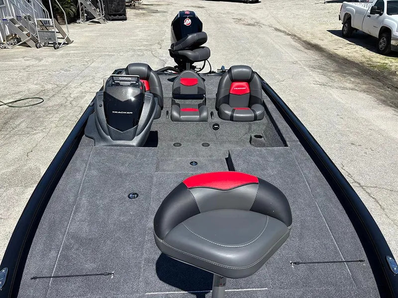 Slide: The Image of 2025 Tracker Savage 215 boat interior with gray and red seating, spacious deck layout. - 11