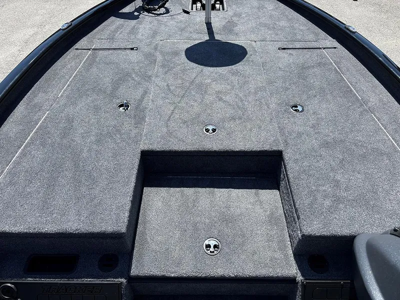 Slide: The Image of 2025 Tracker Savage 215 boat deck with gray carpeting and storage compartments. - 13