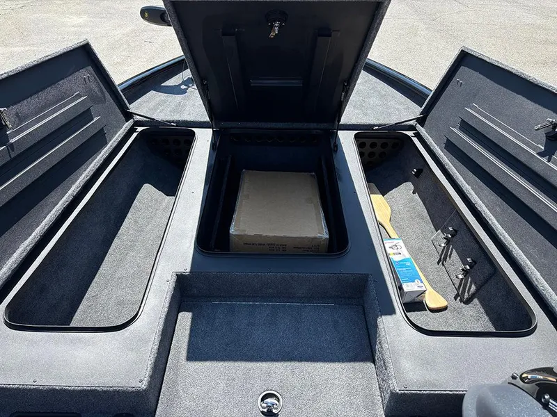Slide: The Image of 2025 Tracker Savage 215 boat storage compartments with open hatches and visible equipment. - 14