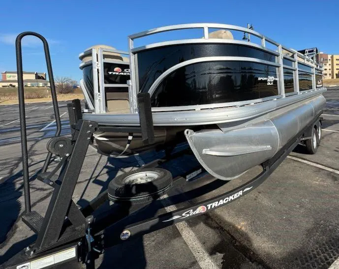 Slide: The Image of 2025 Sun Tracker SportFish 20 DLX pontoon boat on trailer in parking lot. - 3