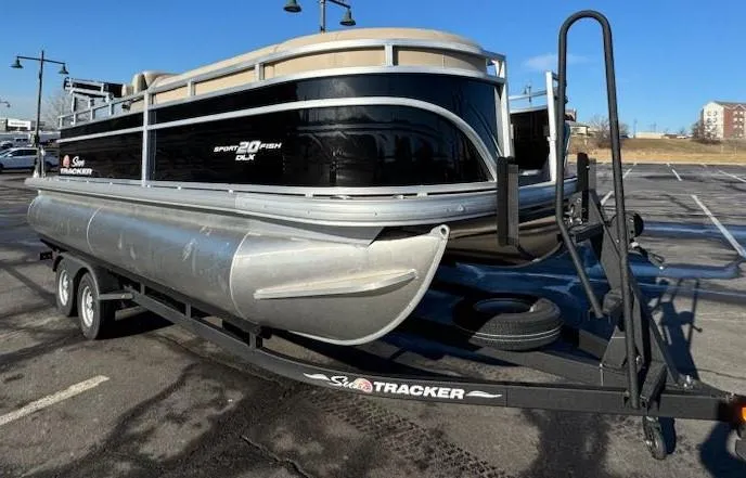 Slide: The Image of 2025 Sun Tracker SportFish 20 DLX pontoon boat on trailer in parking lot. - 4