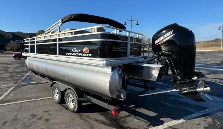 Slide: The Image of 2025 Sun Tracker SportFish 20 DLX pontoon boat with Mercury outboard motor on trailer. - 5